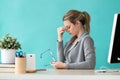 Tired young business woman having headache while working with computer in the office Royalty Free Stock Photo