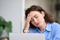 Tired young business woman touching head feeling headache fatigue at work. Royalty Free Stock Photo