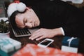 Tired Young Businessman in Office on New Year Eve. Royalty Free Stock Photo