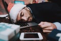 Tired Young Businessman in Office on New Year Eve. Royalty Free Stock Photo