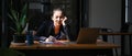 Tired businesswoman sitting at her office desk with laptop computer. Royalty Free Stock Photo