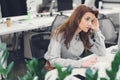 Tired young businesswoman using desktop computer Royalty Free Stock Photo