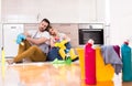 Tired young couple after chores sitting on floor