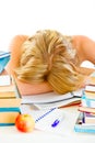 Tired young girl sleeping at table with books Royalty Free Stock Photo