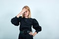 Tired young lady ikeeping eyes closed and putting hand on nose isolated on wall Royalty Free Stock Photo