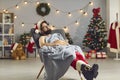 Tired young man dressed as Santa Claus sleeping peacefully in a cozy armchair under warm blanket Royalty Free Stock Photo