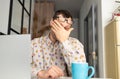 Tired young man facing pain, tired eyes, holding glasses, rubbing irritated eyes, fatigue from working at a computer Royalty Free Stock Photo