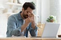 Tired young man feel eyestrain holding glasses fatigued from computer Royalty Free Stock Photo