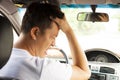 Tired young man have a headache while driving car. Royalty Free Stock Photo