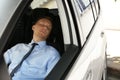 Tired young man sleeping in his car Royalty Free Stock Photo