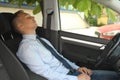 Tired young man sleeping in his car Royalty Free Stock Photo