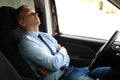 Tired young man sleeping in his car Royalty Free Stock Photo