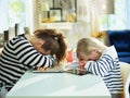 Tired young mother and child laying on table