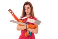 Tired young slim builder girl makes renovations with tools in her hands isolated on white background Royalty Free Stock Photo