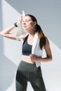 tired young sportswoman with towel wiping sweat Royalty Free Stock Photo