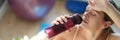 Tired young woman drinks water after training closeup Royalty Free Stock Photo