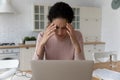 Tired young woman feels unwell while sit near laptop Royalty Free Stock Photo