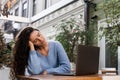 Tired young woman have a break at work and sleeping and relaxing at laptop on workplace due to overtime work. Sleeping Royalty Free Stock Photo