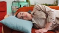 Tired young woman girl lying down in bed taking a rest at home, napping, falling asleep on couch Royalty Free Stock Photo