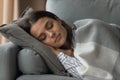 Tired young woman relax on couch sleeping Royalty Free Stock Photo