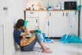 Tired young woman sitting on kitchen floor Royalty Free Stock Photo