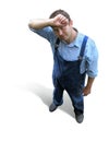 A tired young worker in working clothes, looked from above Royalty Free Stock Photo
