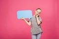 tired youngster relaxing and holding blue speech bubble, isolated