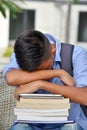 Tired Youthful Asian Person With Books