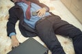 Tiredness businessman sleeping in suit with bag and mobile on ha Royalty Free Stock Photo