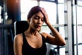 tiredness from exercise by lifting weights and sit back and wipe the sweat off your face. Muscular and strong body Royalty Free Stock Photo