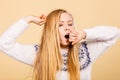 Sleepy yawning teenage woman in jumper