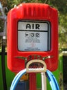 Out-dated red tireflator, vintage item of excess air meter at filling station