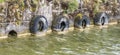 Tires hanging on the side of a pier in the harbor Royalty Free Stock Photo