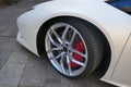 Tires and rims of a modern white sports car. Front of the vehicle, side view