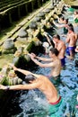 Locals and tourists going for ritual purification in the holy spring waters of this temple founded around a large water spring.