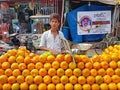 Tiruvanamalai, India - 29 december 2019: Young street seller selling oranges in the streets of Tiruvanamalai India