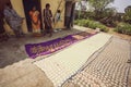 Indian women drying papad chips on the sun