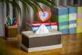 A tissue box on a wooden reading table.