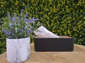 Tissue boxes and flower artificial on the table with leaves in the background Royalty Free Stock Photo