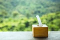 Tissue boxes on wooden table with blur natural mountain view background. Royalty Free Stock Photo