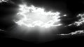 Title: A dramatic black and white sky with bright sunlight breaking through the clouds Royalty Free Stock Photo