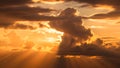Title: Dramatic sunset with golden rays of light breaking through dark clouds over the horizon Royalty Free Stock Photo