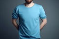 Young man in blank blue t-shirt on grey background. Mock up Ai generative Royalty Free Stock Photo