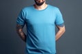 Young man in blank blue t-shirt on grey background. Mock up Ai generative Royalty Free Stock Photo