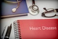 Titled red book Heart Disease along with medical equipment