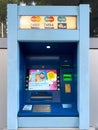 Tivat, Montenegro - 09 august 2023: Blue street ATM with different inscriptions. Lettering: Visa, Mastercard, Maestro