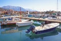 Fishing boats in harbor. Montenegro. View of Marina Kalimanj in Tivat city against Lovcen mountain Royalty Free Stock Photo