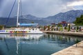Tivat, Montenegro 07/07/2016: pleasure sailing catamaran on the pier against the backdrop of the mountains. Beautiful landscape