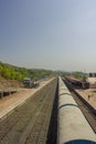 Indian passenger train stands near the train platform with people, view from above