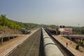 Indian train stands near the railway platform with people, top view